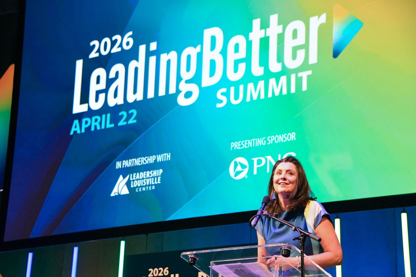 A speaker welcomes the audience from the podium at the 2026 LeadingBetter Summit, presented by PNC